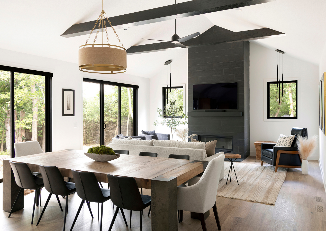 Spacious living room with large windows, neutral décor, and custom finishes in a Cardinal Realty home