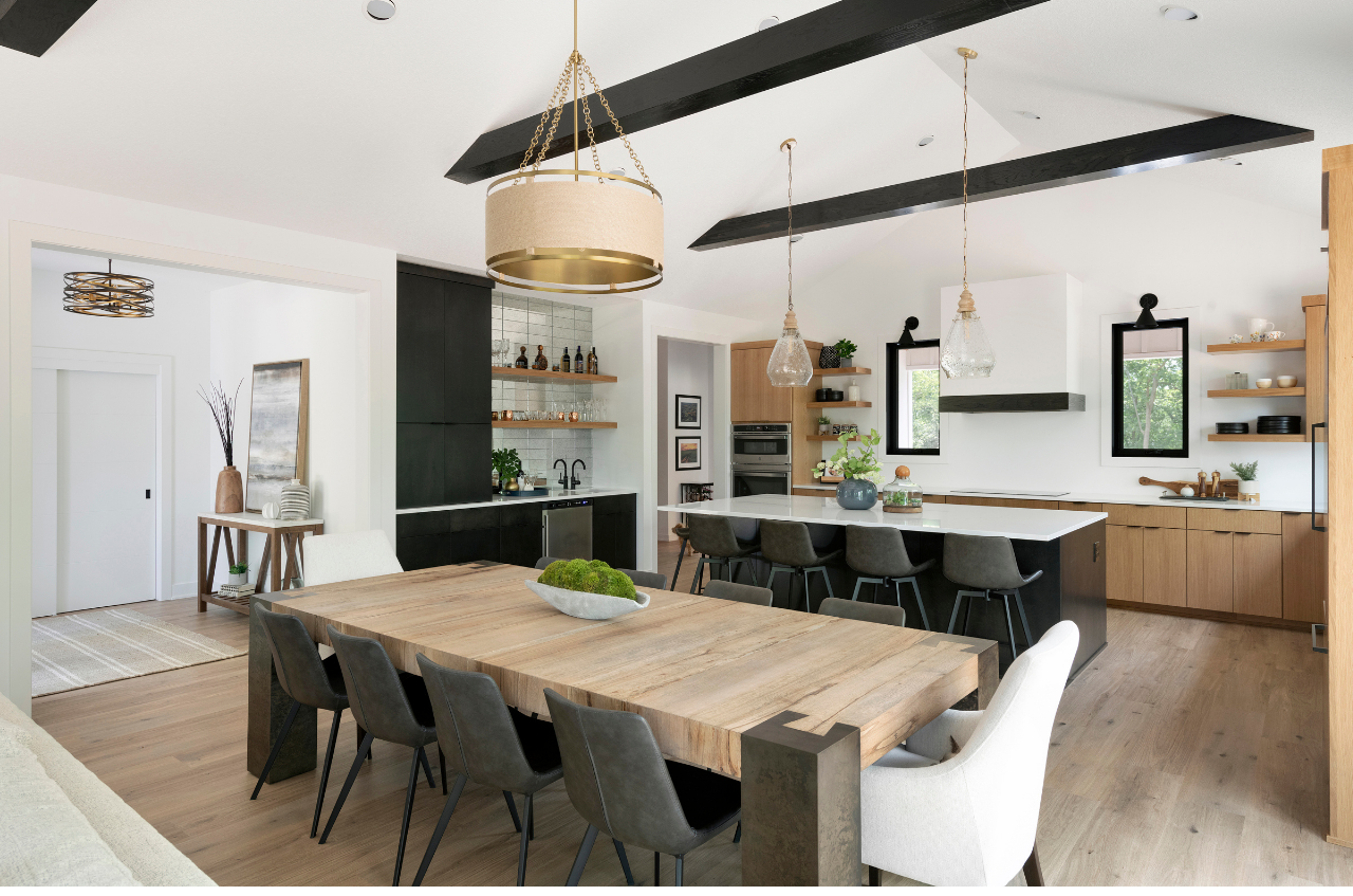 Bright kitchen with white cabinetry, large island, and stainless steel appliances in a Cardinal Realty new home