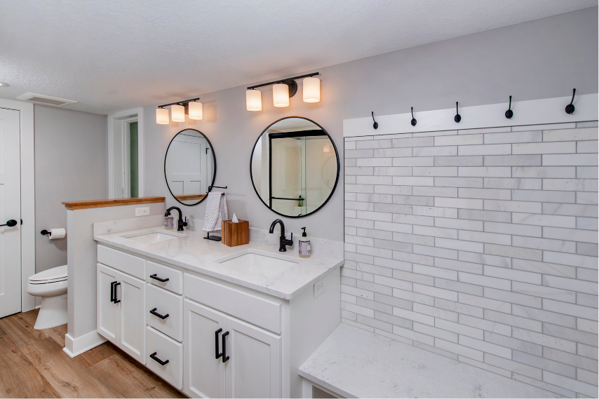 Luxury bathroom remodel with double vanity, custom tile shower, and modern fixtures by Cardinal Remodeling.