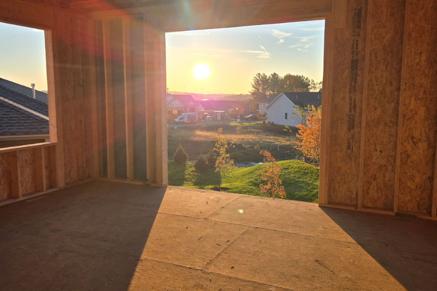 Cardinal Homes villa under construction in Cottage Grove, showing progress on framing and exterior work for a new residential build.