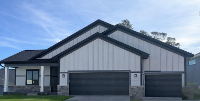 Cardinal Homes villa under construction in Cottage Grove, showing progress on framing and exterior work for a new residential build.