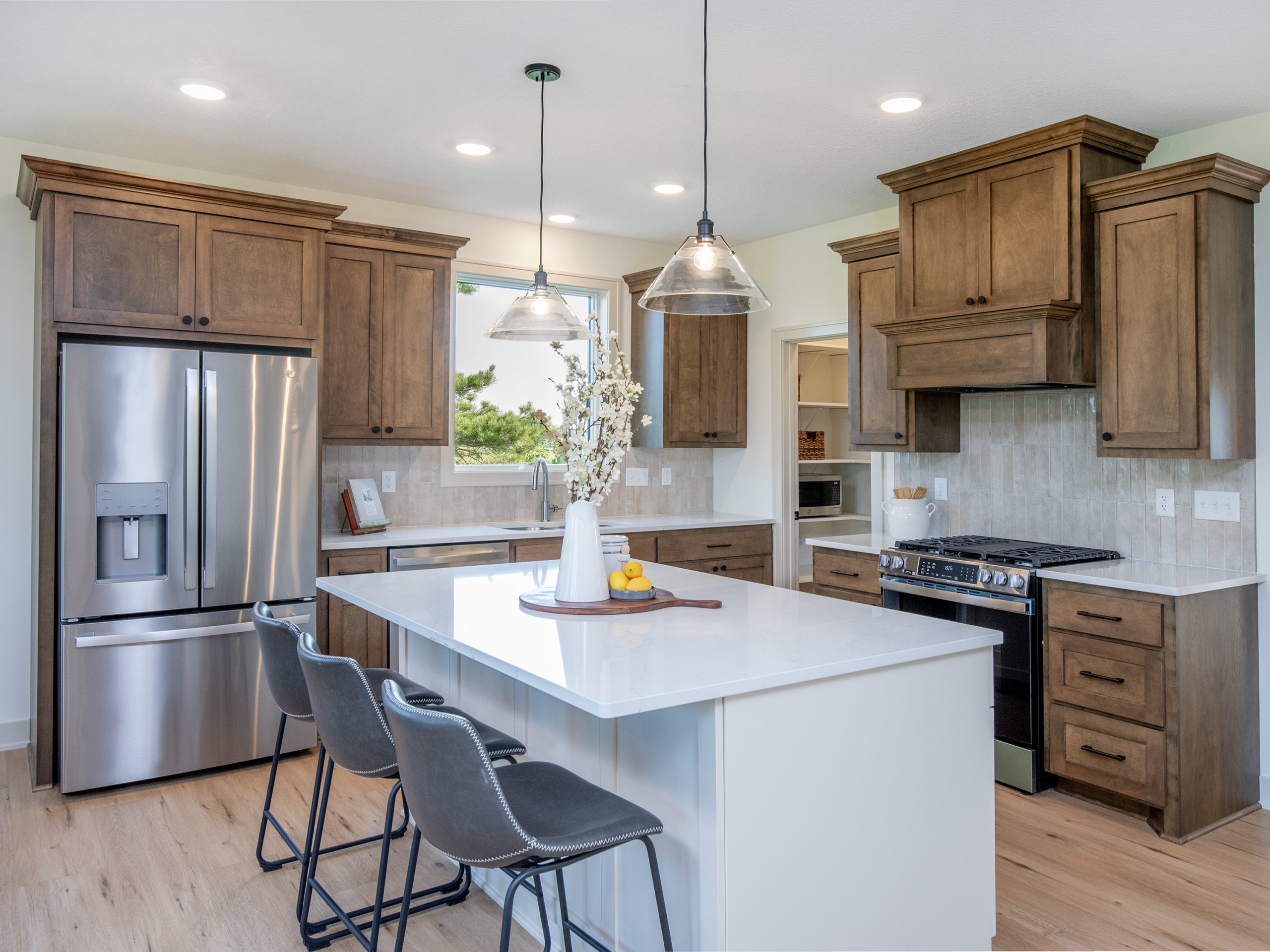 Rendering of a customizable Cardinal Reserve villa with stone accents, front porch, and attached two-car garage, available to build on homesites in Cottage Grove.